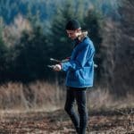 teacher in the woods looking at a map