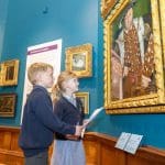 two primary school children looking at henry the eight painting