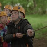 school pupils in hard hats pulling a rope challenge