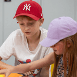 school pupils solving a puzzle at the videogame museum