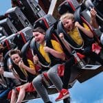 primary school students on a theme park ride whizzing high in the sky