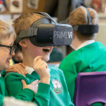school pupils in class wearing VR headset