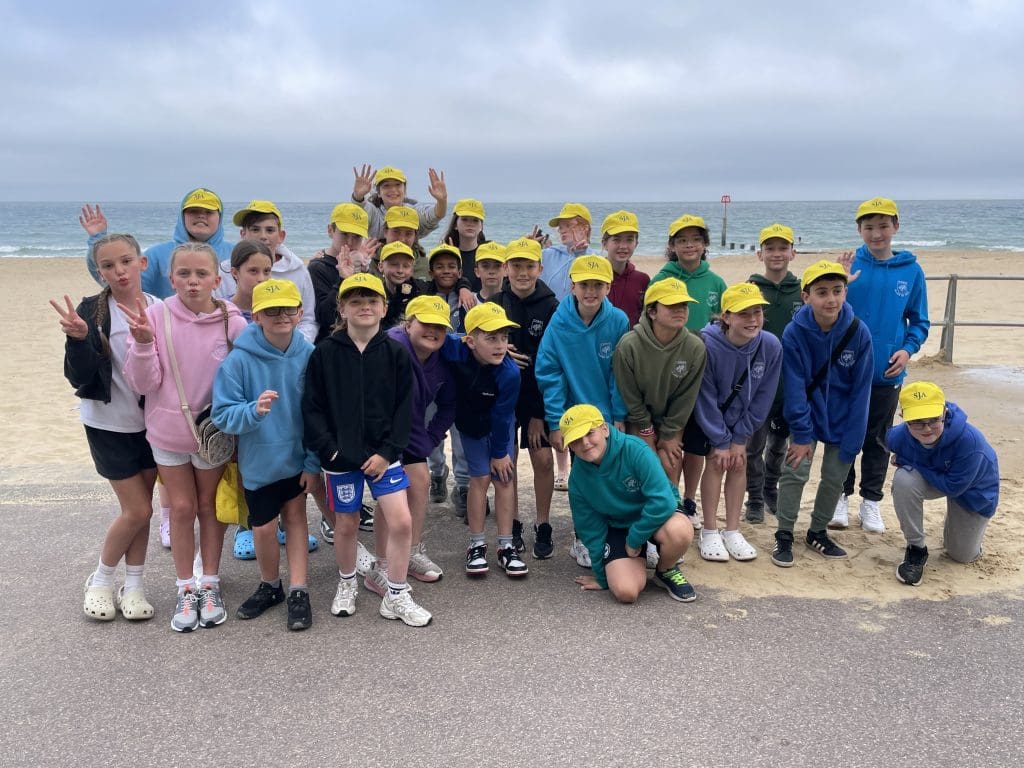 The School Journey Association School Trips 7 school group at the seaside having a photo taken of their school trip