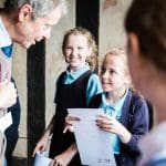 school pupil handing an information sheet to a learning provider at the Shakespeare schoolroom and guildhall