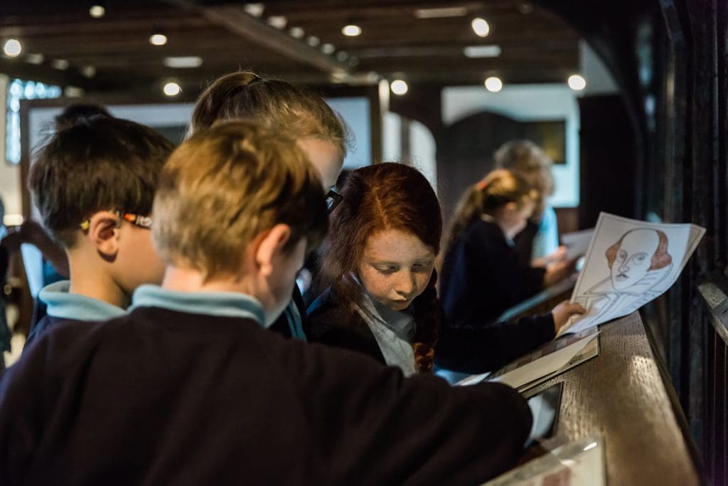 school pupils drawing William Shakespeare in a study room at the museum