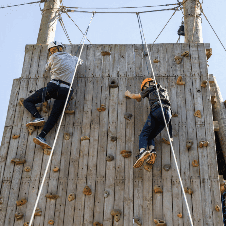two secondary school pupils on a outdoor climbing wall