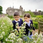 school pupils looking at a flower garden