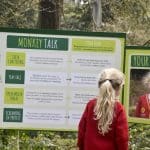 school pupil looking at an information sign explaining about Monkey talk and actions
