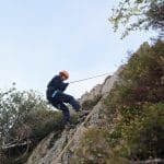 school pupil abseiling down a mountain in the Lake District