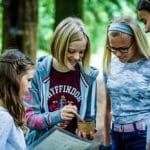 group of students doing study tasks at an Arboretum