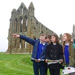 school group at an abbey on a tour of the grounds