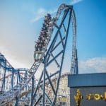 school group on a roller coaster ride waving