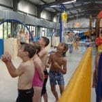 school pupils on indoor water slides