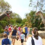dinosaur land with school pupils walking around outside