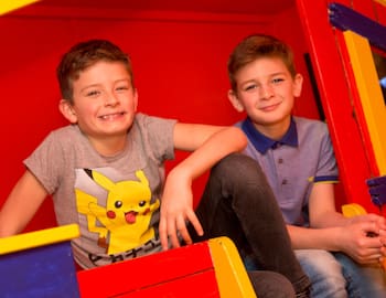 pupils sitting in an indoor play area