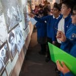 school group looking at pictures on a museum wall