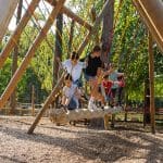 primary pupils playing on a swing outside