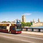 open top bus by the river themes in London with a school group tour