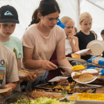 school children in a canteen area getting food