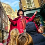 tour guide in a street in York doing the magical walking tour
