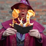 walking tour person in wizard clothing with a burning book