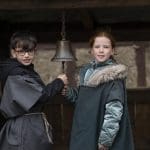 school pupils ringing a bell
