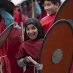 student in Celtic clothing with spear and shield