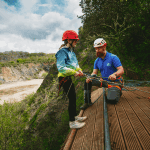 student and instructor at the top of a climbing tower