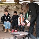 pupils around a camp fire pit