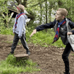 school pupils in woodland playing