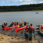 school group doing kayaking on a lake
