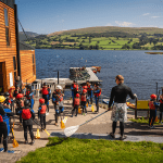 school group near a lake about to canoe