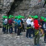 large group of pupils doing rock climbing in Dorset