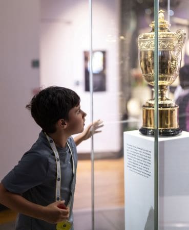 school pupil looking at a trophy cabinet