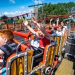 school group on a mini roller coaster at a adventure park