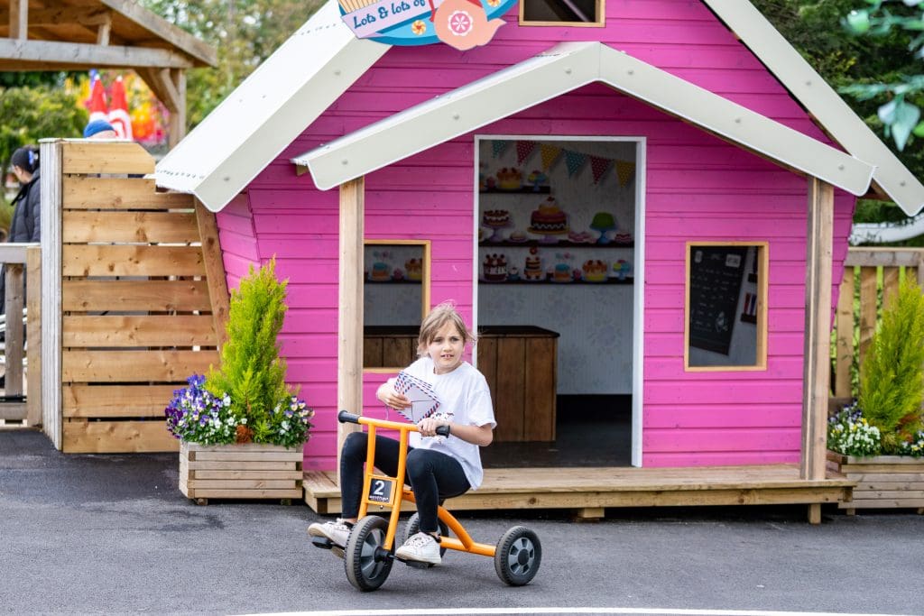 primary school pupil on a tricycle outside