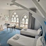 dorm room for school trip pupils to stay in with 2 beds, table and sink area