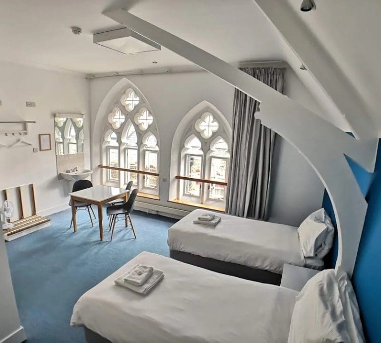 dorm room for school trip pupils to stay in with 2 beds, table and sink area
