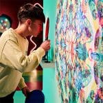 school pupil looking at images on a wall with a magnifying glass