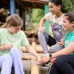 school pupils making a raft of bamboo and plastic barrels