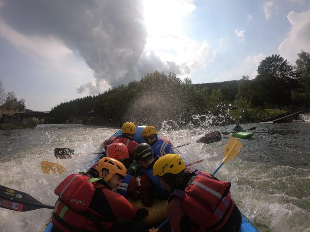 school group in a white water rapids dingy