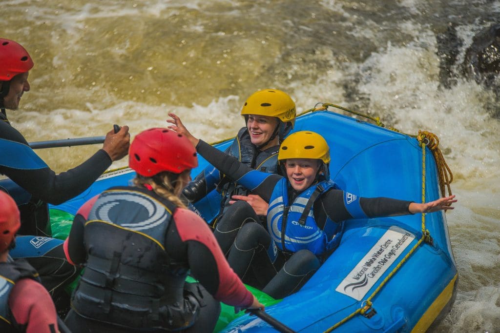 school group in a dingy on a river rapids