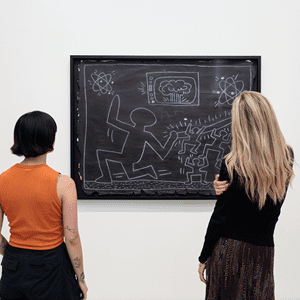 students looking at picture on a museum wall