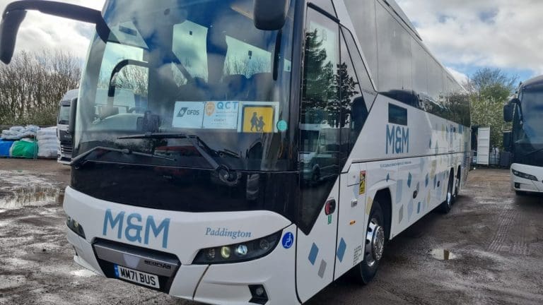 side view of a school coach in a car park