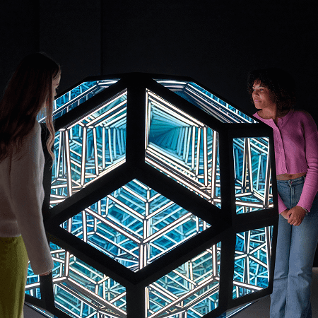 pupils looking at a large 4D piece of art work