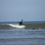 group surfing at the coast in Devon