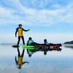 two students body boarding
