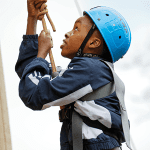 school pupil climbing up a tower
