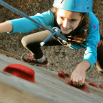 school pupil climbing a wall