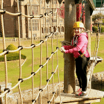 girl high up on a high ropes activity centre
